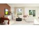 Stylish living room with a comfortable sectional sofa, modern furniture, and large windows at 11732 Brae Way, Dade City, FL 33525
