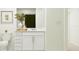 Clean bathroom featuring a white vanity, toilet, and greenery for a fresh touch at 11746 Brae Way, Dade City, FL 33525