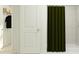 Modern bathroom featuring a tiled shower and a door to an organized closet at 11746 Brae Way, Dade City, FL 33525