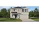 Charming two-story home features a classic design, manicured lawn, and a two-car garage at 11746 Brae Way, Dade City, FL 33525