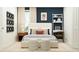 This spacious main bedroom has decor on the wall, layered pillows on the bed, and a shelf behind the bed at 11746 Brae Way, Dade City, FL 33525