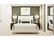 This main bedroom boasts a plush bed with throw pillows and a decorative art piece above the headboard at 11746 Brae Way, Dade City, FL 33525