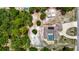 Aerial view of a landscaped property featuring a home with a screened-in pool and mature trees at 13110 Manistee Rd, Weeki Wachee, FL 34614