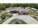 Large home with a screened-in pool, spacious circular driveway and 3-car garage on an oversized lot at 13110 Manistee Rd, Weeki Wachee, FL 34614