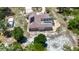Aerial view of the property showcasing the home, pool, outbuilding, and surrounding landscape at 13110 Manistee Rd, Weeki Wachee, FL 34614