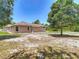 Backyard view showcasing the home's exterior and lush surrounding greenery at 13110 Manistee Rd, Weeki Wachee, FL 34614