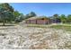 View of the backyard, featuring the home's exterior and a screened-in pool enclosure at 13110 Manistee Rd, Weeki Wachee, FL 34614