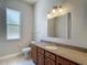 Bathroom with a granite countertop and a wooden vanity with cabinets at 13110 Manistee Rd, Weeki Wachee, FL 34614