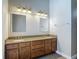 Bathroom features a double vanity with granite counters, decorative lights, and a neutral color scheme at 13110 Manistee Rd, Weeki Wachee, FL 34614