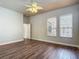 Spacious bedroom with wood look flooring and a fan with light kit at 13110 Manistee Rd, Weeki Wachee, FL 34614