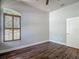An empty bedroom with shutters on the windows and dark brown wood look floors at 13110 Manistee Rd, Weeki Wachee, FL 34614