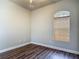 Cozy bedroom featuring wood floors and a window with wooden blinds at 13110 Manistee Rd, Weeki Wachee, FL 34614