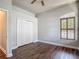 Bedroom with a ceiling fan, arched window and closet at 13110 Manistee Rd, Weeki Wachee, FL 34614