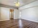 Spacious bedroom with wood look flooring, neutral paint and fan with light kit at 13110 Manistee Rd, Weeki Wachee, FL 34614