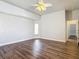Spacious bedroom with wood look flooring, neutral paint, and a fan with light kit at 13110 Manistee Rd, Weeki Wachee, FL 34614