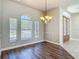 Dining room with hardwood floors, complemented by elegant lighting and large windows at 13110 Manistee Rd, Weeki Wachee, FL 34614
