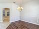 Bright dining area with hardwood floors and large windows, enhanced by wainscoting details at 13110 Manistee Rd, Weeki Wachee, FL 34614