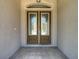 Elegant double front doors with decorative glass panels and a tiled entryway at 13110 Manistee Rd, Weeki Wachee, FL 34614
