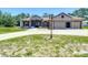 Inviting single-story home with a three-car garage, long driveway, and charming curb appeal at 13110 Manistee Rd, Weeki Wachee, FL 34614