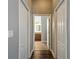 Hallway with views to the bathroom, light walls and wood look floors at 13110 Manistee Rd, Weeki Wachee, FL 34614