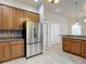 Well-designed kitchen with stainless steel refrigerator and light wood cabinets at 13110 Manistee Rd, Weeki Wachee, FL 34614
