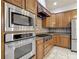 Bright kitchen featuring stainless steel appliances and tiled backsplash at 13110 Manistee Rd, Weeki Wachee, FL 34614