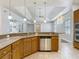 Open concept kitchen with stone countertops and stainless steel dishwasher at 13110 Manistee Rd, Weeki Wachee, FL 34614