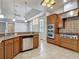 Open kitchen features granite countertops, stainless appliances and a breakfast bar overlooking the living area at 13110 Manistee Rd, Weeki Wachee, FL 34614