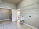 Large laundry room with overhead shelves and a utility sink at 13110 Manistee Rd, Weeki Wachee, FL 34614