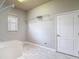 A spacious laundry room with wire shelving and a utility sink at 13110 Manistee Rd, Weeki Wachee, FL 34614