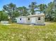 Charming outbuilding with a white exterior, offering additional storage or flexible space at 13110 Manistee Rd, Weeki Wachee, FL 34614