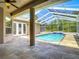 Inviting pool with screened enclosure and brick accents, creating a perfect backyard oasis at 13110 Manistee Rd, Weeki Wachee, FL 34614