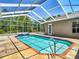 Enclosed pool offers privacy and sunlight, surrounded by a clear screen for year-round enjoyment at 13110 Manistee Rd, Weeki Wachee, FL 34614