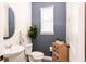 Stylish powder room with vessel sink, accent wall, and decorative shelving at 14245 Damselfly Dr, Tampa, FL 33625