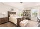 Inviting main bedroom with tray ceiling, large windows, and built-in bookshelf at 14245 Damselfly Dr, Tampa, FL 33625