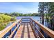 A wooden community dock extends over tranquil lake water with scenic views of lush greenery at 14245 Damselfly Dr, Tampa, FL 33625