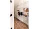 Well-organized pantry with white wire shelving and wood-look tile flooring at 14245 Damselfly Dr, Tampa, FL 33625