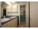 Functional bathroom with a double sink vanity and blue bathtub/shower at 1444 Eastfield Dr, Clearwater, FL 33764