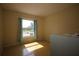 Bright bedroom with large window and beige walls at 1444 Eastfield Dr, Clearwater, FL 33764