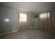 Well-lit bedroom featuring tile floors and two windows with curtains at 1444 Eastfield Dr, Clearwater, FL 33764