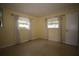 Cozy bedroom with two windows offering natural light and neutral walls at 1444 Eastfield Dr, Clearwater, FL 33764