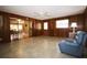Spacious bonus room boasts wood paneling, a ceiling fan, and access to the backyard at 1444 Eastfield Dr, Clearwater, FL 33764