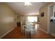 Lovely dining space showcasing hardwood floors, decorative wainscoting, and natural light at 1444 Eastfield Dr, Clearwater, FL 33764