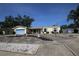 Charming home boasts a well-manicured lawn, colorful flower beds, and a two-car garage at 1444 Eastfield Dr, Clearwater, FL 33764
