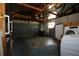 Open garage space with exposed ceiling and equipped with washer, dryer, and storage shelves at 1444 Eastfield Dr, Clearwater, FL 33764