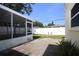 Covered, screen-enclosed lanai and patio area with paver stones and view of the yard at 1444 Eastfield Dr, Clearwater, FL 33764