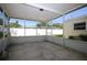 Screen-enclosed lanai with paver flooring, offering an outdoor living space with views of the backyard at 1444 Eastfield Dr, Clearwater, FL 33764