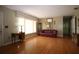 Bright living room with hardwood floors, large windows, and ample space for entertaining at 1444 Eastfield Dr, Clearwater, FL 33764