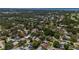 Aerial view of neighborhood showcasing the home's location in a lush, tree-filled community near the water at 1503 Albemarle Ct, Dunedin, FL 34698