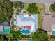 Overhead view of home with a pool, patio and firepit plus the adjacent boat parking area at 1503 Albemarle Ct, Dunedin, FL 34698